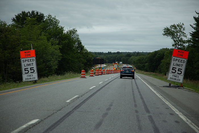 Picture of car on highway near road work